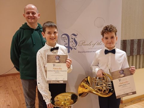 abi laureāti kopā ar skolotāju